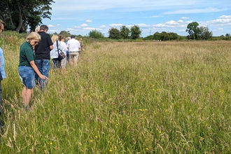 Visitors at the Bridewell Common opening event enjoying a tour of the new nature reserve