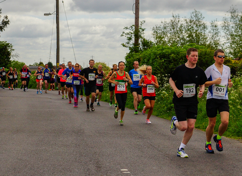 People running on a road outdoors